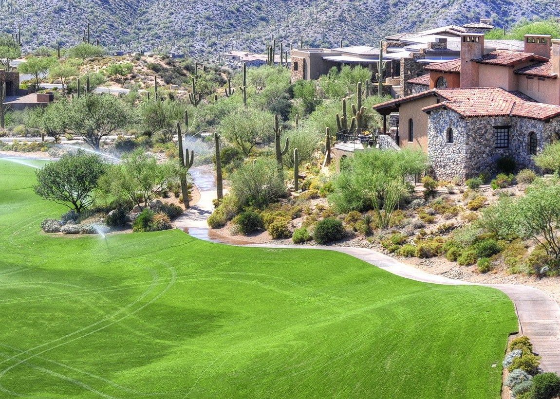 Desert homes overlooking a green fairway in the Arizona foothills